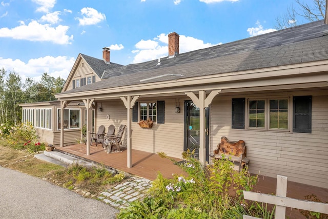 back of property with a sunroom