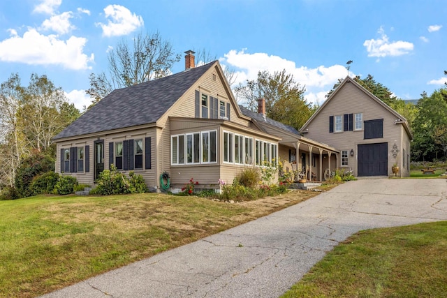 view of property with a garage and a front yard