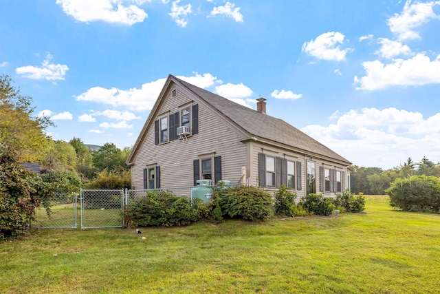 view of home's exterior featuring cooling unit and a yard