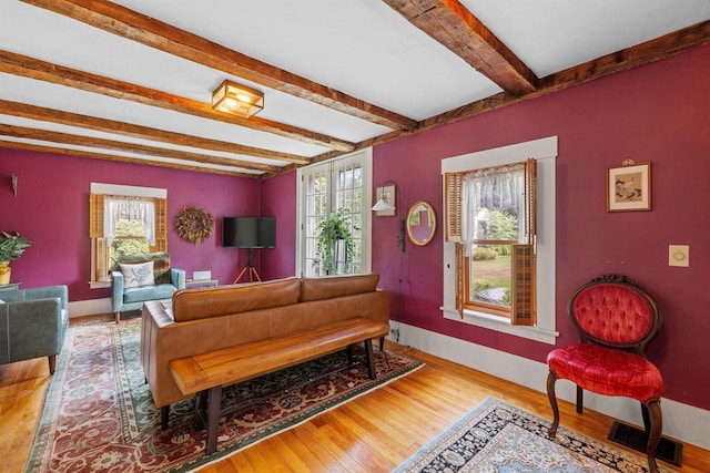 living room with wood-type flooring and beamed ceiling