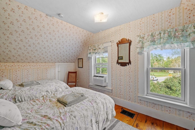 bedroom featuring cooling unit and wood-type flooring