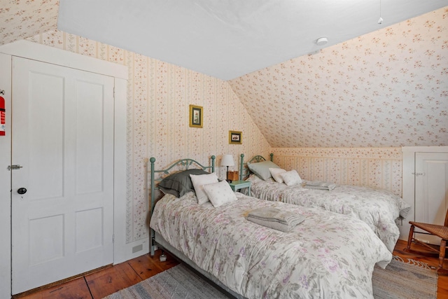 bedroom featuring hardwood / wood-style flooring and lofted ceiling