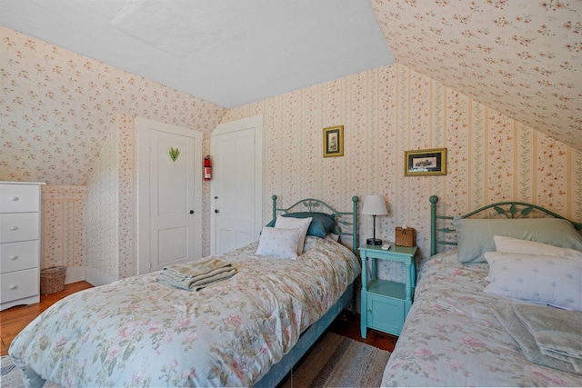 bedroom featuring lofted ceiling and dark wood-type flooring