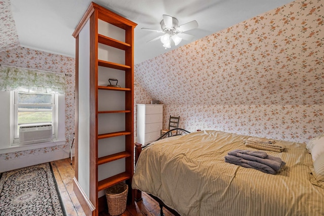 bedroom with cooling unit and hardwood / wood-style flooring