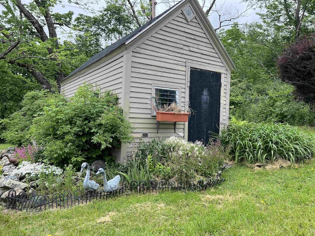 view of outbuilding featuring a yard