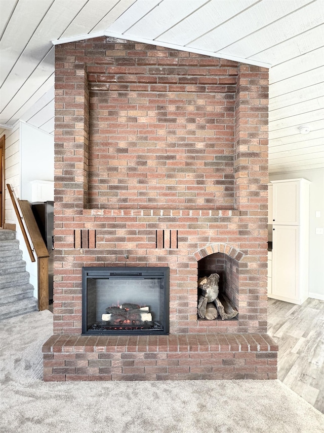 interior details with a brick fireplace, hardwood / wood-style floors, and wooden ceiling