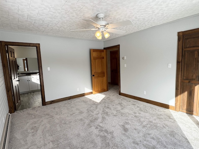 unfurnished bedroom featuring connected bathroom, a baseboard heating unit, light carpet, and ceiling fan