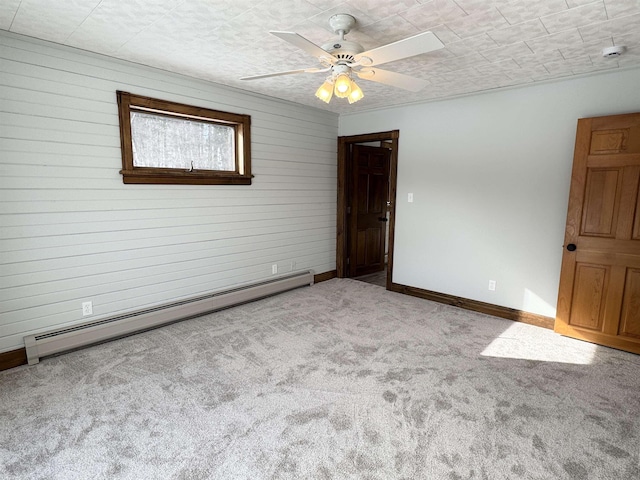 carpeted empty room with ceiling fan and a baseboard radiator