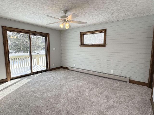 unfurnished room featuring light carpet, a wealth of natural light, a baseboard radiator, and a textured ceiling