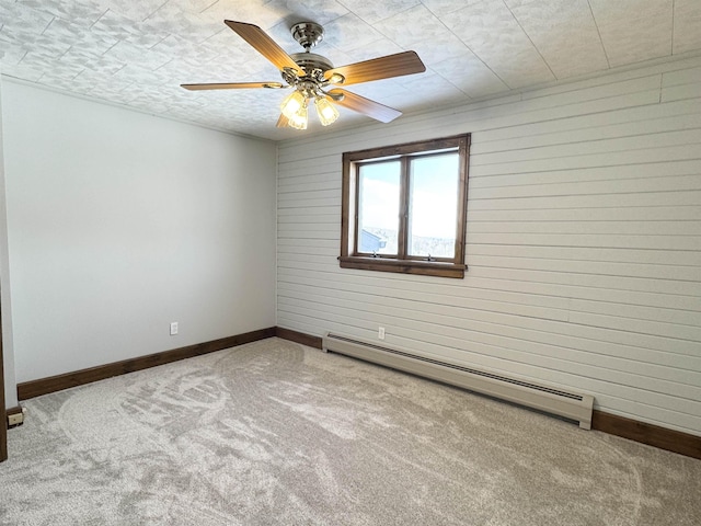 carpeted spare room featuring ceiling fan, a textured ceiling, and baseboard heating