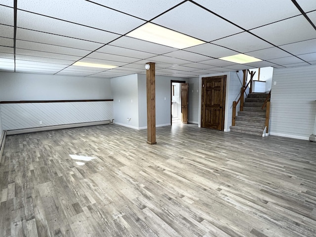 basement with hardwood / wood-style floors and a drop ceiling