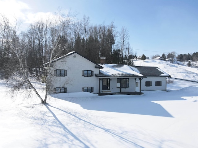 view of snow covered rear of property