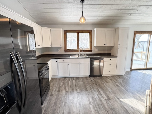 kitchen featuring sink, electric range, dishwasher, refrigerator with ice dispenser, and pendant lighting