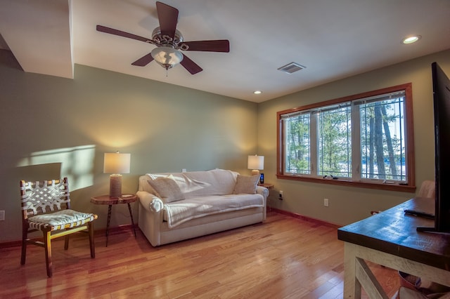 living room with ceiling fan and light hardwood / wood-style floors