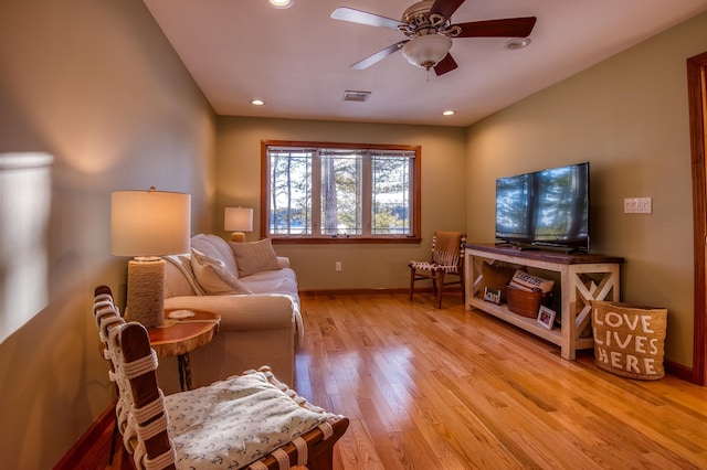 living area featuring ceiling fan and light hardwood / wood-style flooring