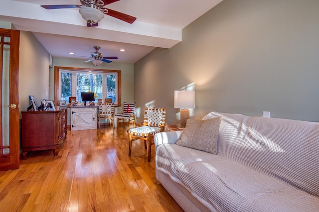 living room with ceiling fan and light hardwood / wood-style floors