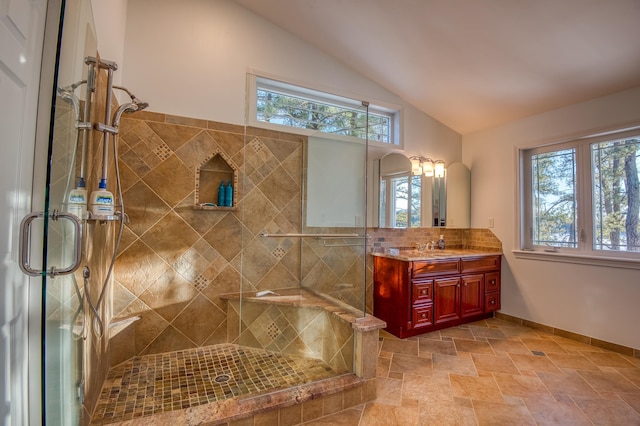 bathroom featuring vanity, decorative backsplash, a shower with shower door, and lofted ceiling