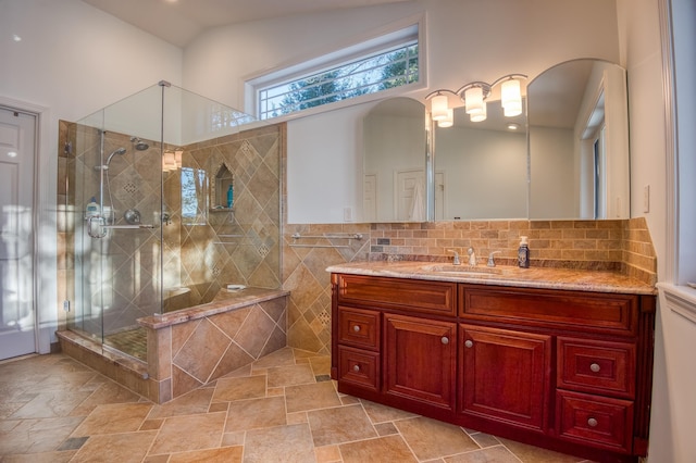 bathroom featuring vanity, lofted ceiling, and walk in shower