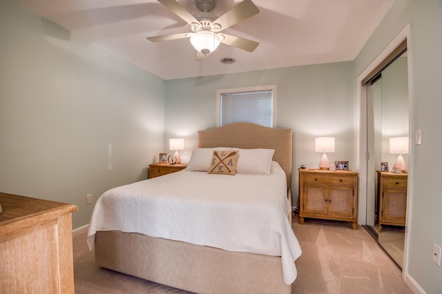 carpeted bedroom featuring ceiling fan and a closet