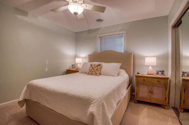 bedroom with light carpet, a closet, and ceiling fan