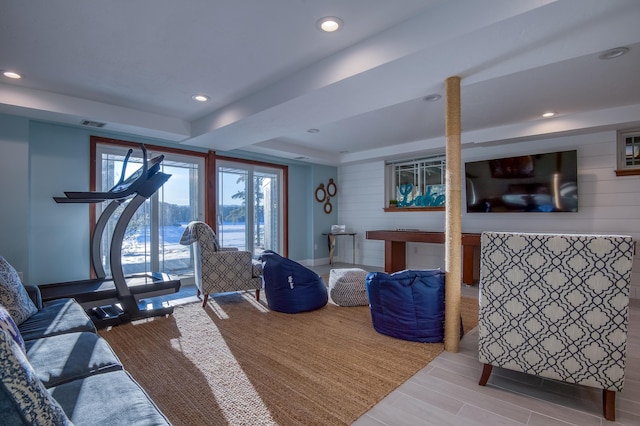 exercise area featuring light hardwood / wood-style flooring and a raised ceiling