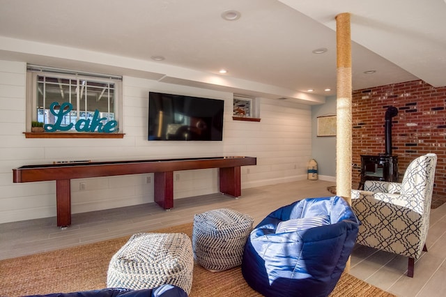 living room featuring a wood stove and light wood-type flooring