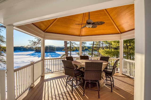 wooden terrace with a gazebo, a water view, ceiling fan, and a view of the beach