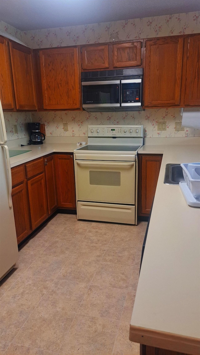 kitchen featuring sink and white appliances