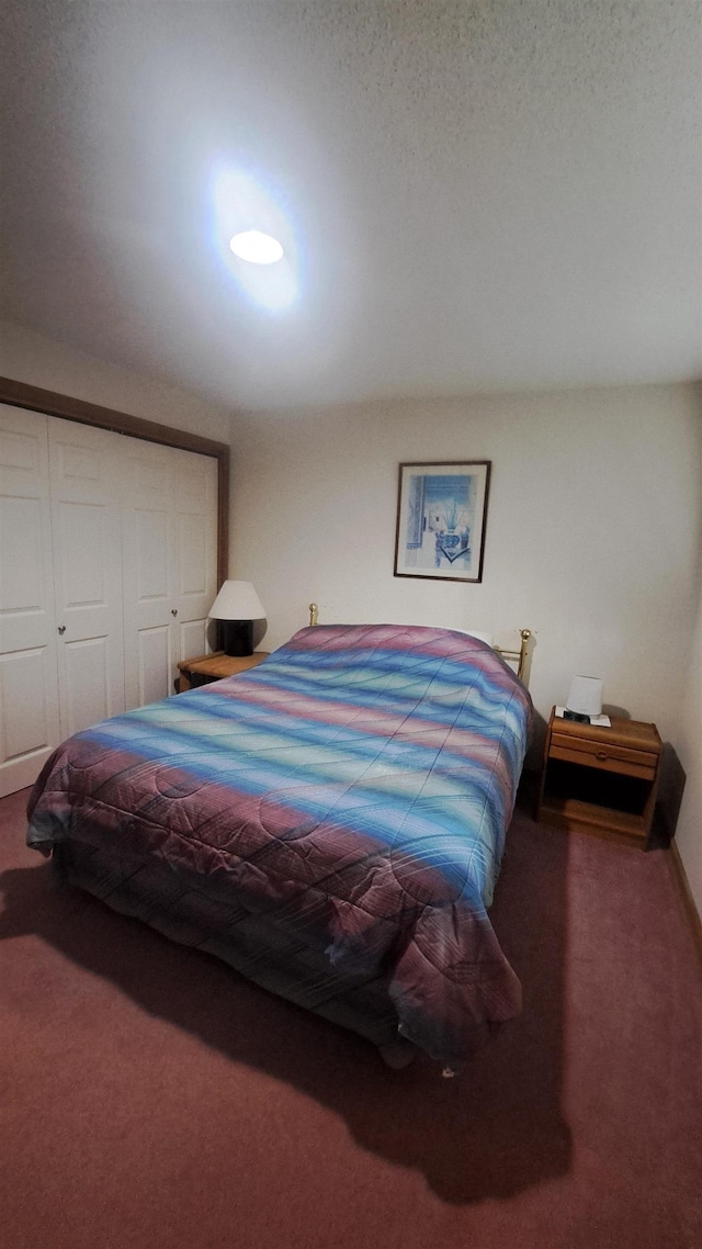 carpeted bedroom featuring a closet