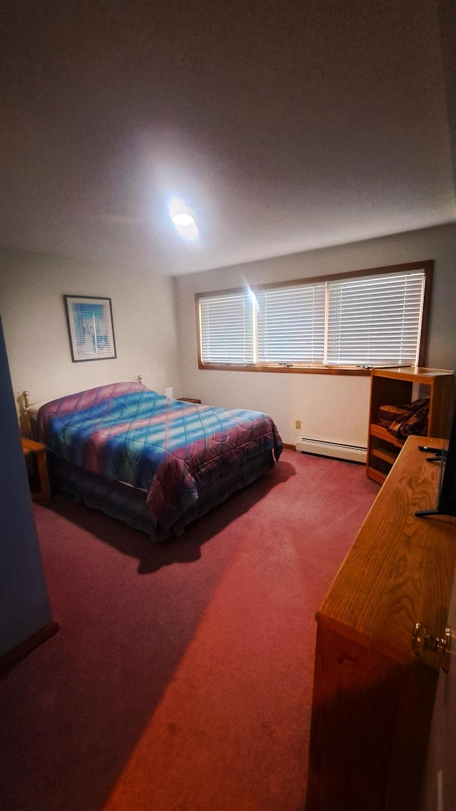 bedroom featuring a baseboard heating unit and carpet