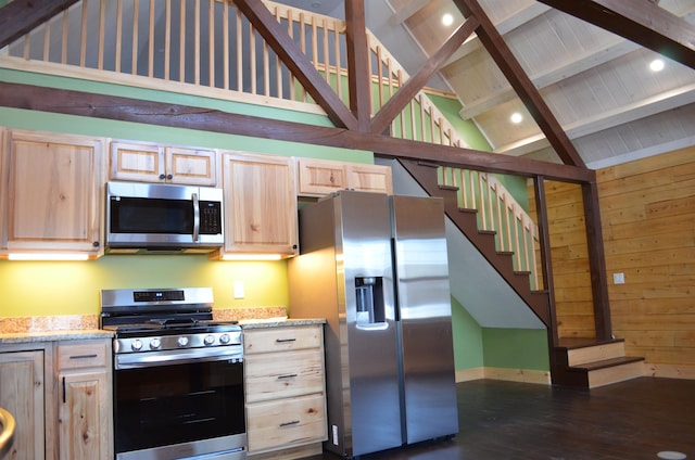 kitchen with high vaulted ceiling, stainless steel appliances, light stone counters, beamed ceiling, and light brown cabinets