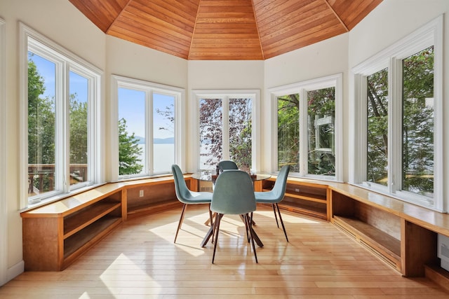 sunroom / solarium with wooden ceiling, lofted ceiling, and a wealth of natural light