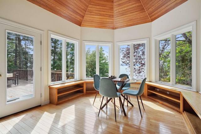 sunroom / solarium featuring vaulted ceiling and wood ceiling