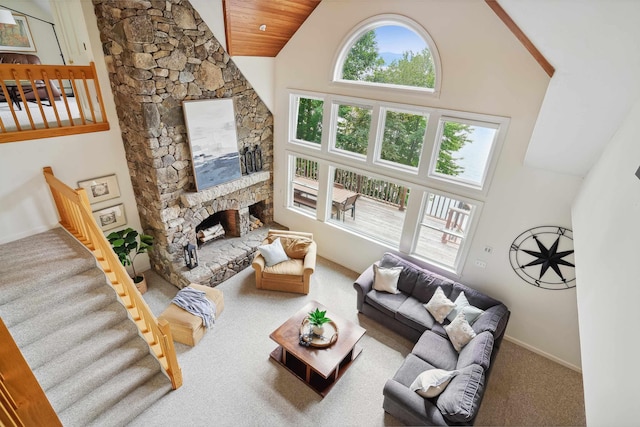 living room featuring wood ceiling, carpet flooring, high vaulted ceiling, and a stone fireplace