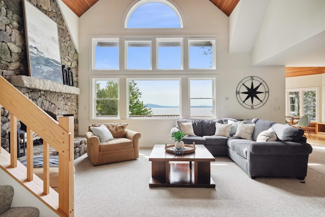 living room featuring carpet flooring, a fireplace, and high vaulted ceiling