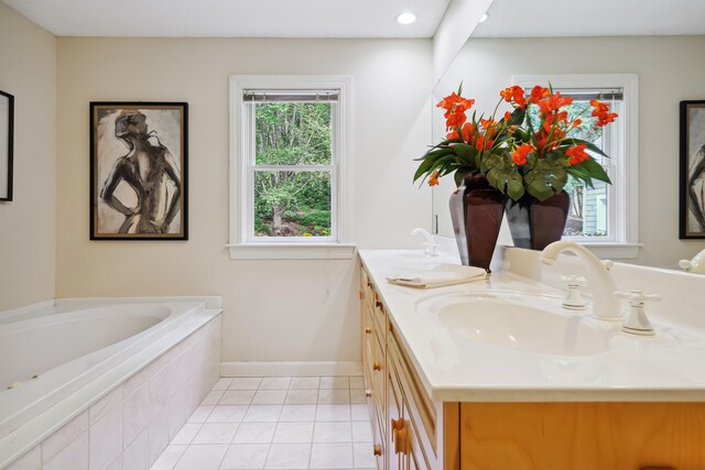 bathroom featuring vanity, a relaxing tiled tub, and tile patterned floors