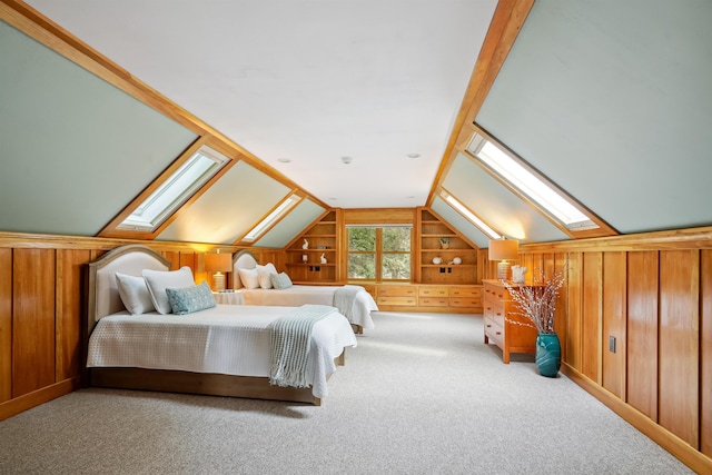 carpeted bedroom with vaulted ceiling with skylight and wood walls