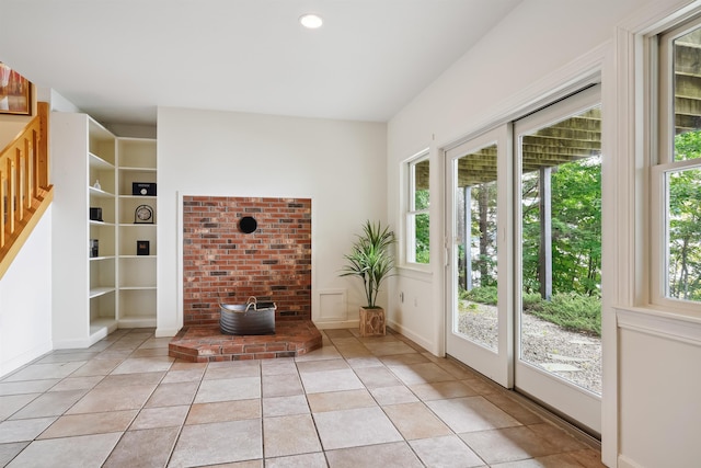 doorway to outside featuring light tile patterned floors and built in features