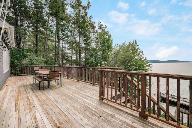 deck with a water and mountain view