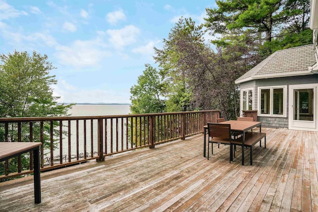 wooden terrace featuring a water view