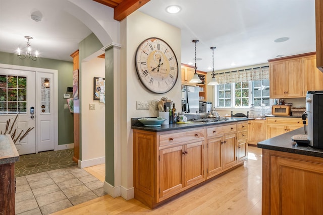 kitchen featuring hanging light fixtures, light wood-type flooring, and appliances with stainless steel finishes