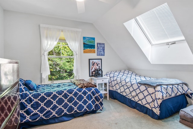 bedroom with ceiling fan, carpet flooring, and vaulted ceiling