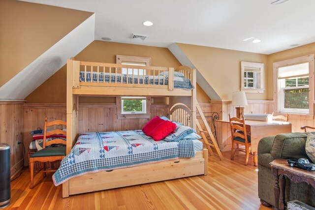 bedroom with multiple windows and light hardwood / wood-style floors