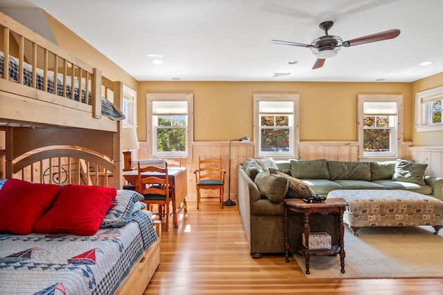 living room featuring ceiling fan and light hardwood / wood-style floors