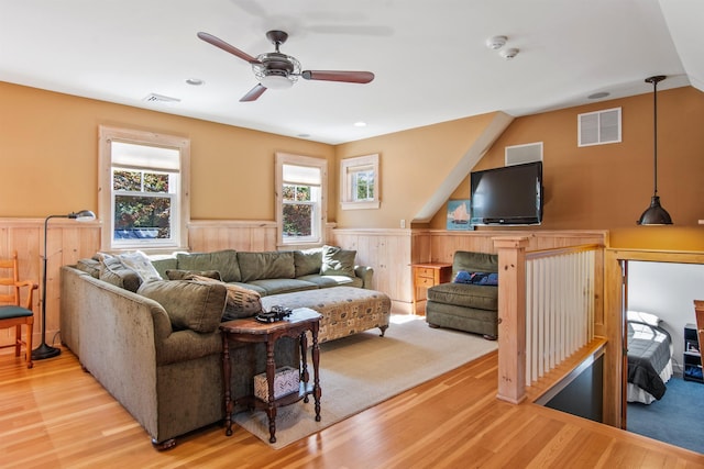 living room with a wealth of natural light, ceiling fan, and light wood-type flooring