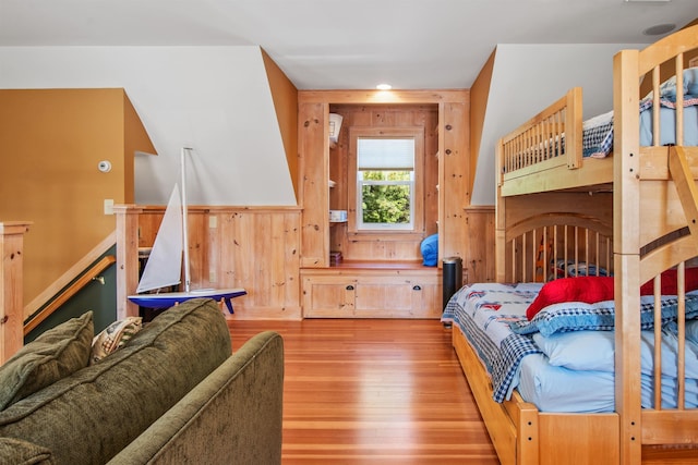 bedroom featuring wood walls and light wood-type flooring