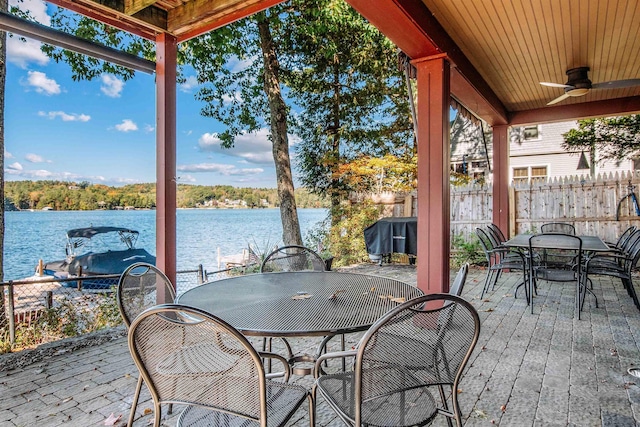 view of patio with a water view and ceiling fan