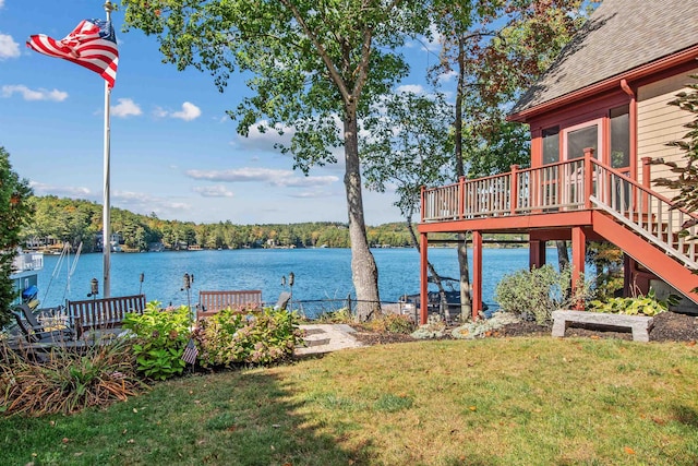 view of dock with a deck with water view and a yard