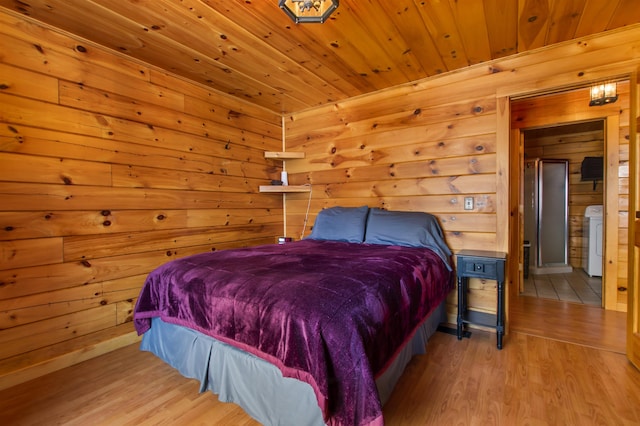 bedroom with washer / dryer, wooden ceiling, wood walls, and light wood-type flooring