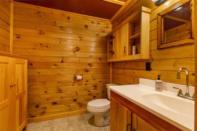 bathroom featuring vanity, toilet, tile patterned flooring, and wood walls